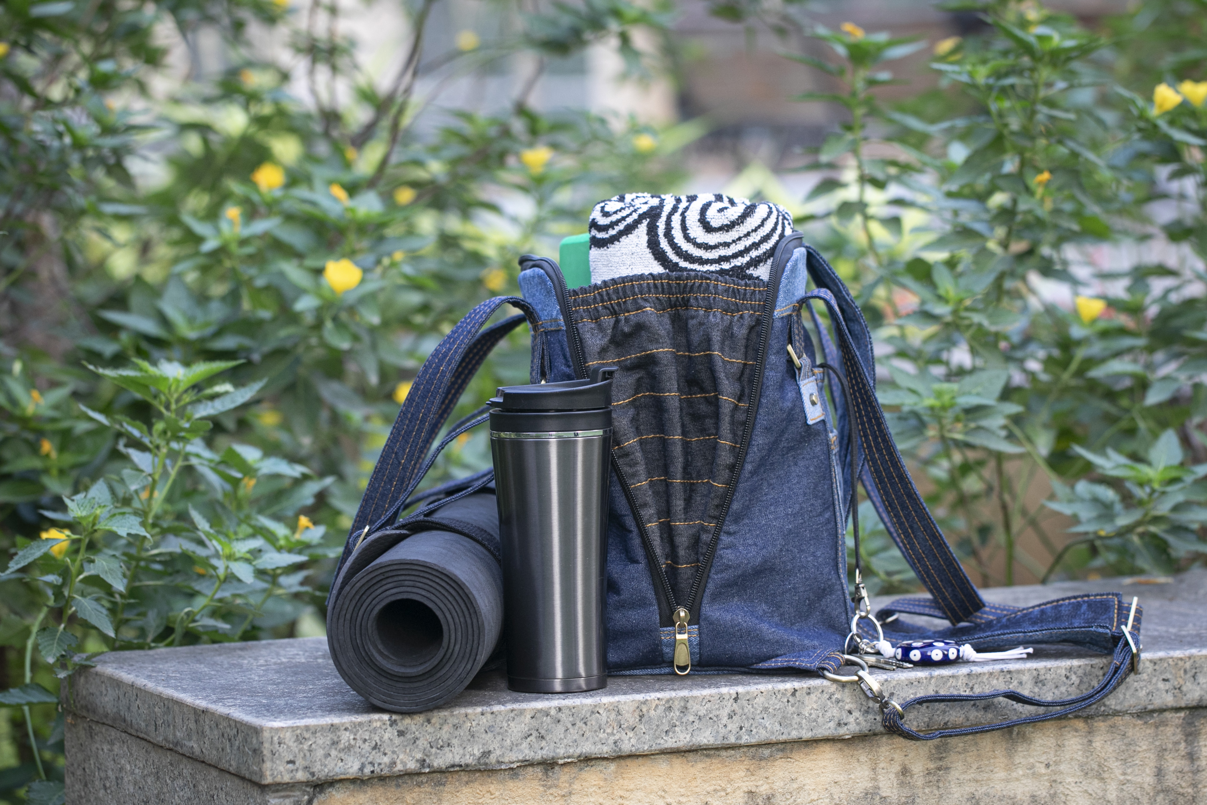 Born Again with a yoga mat held by its adjustable exterior strap