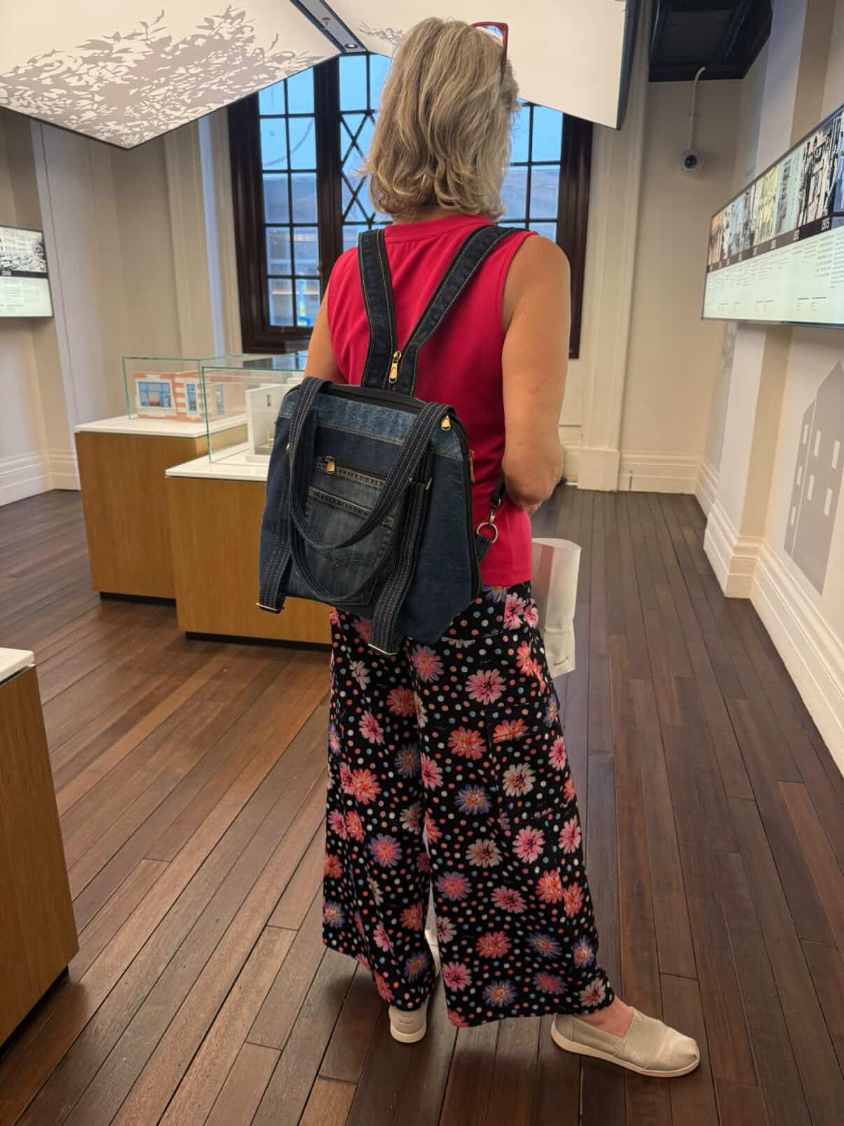 Customer wearing Born Again as a backpack while visiting a museum