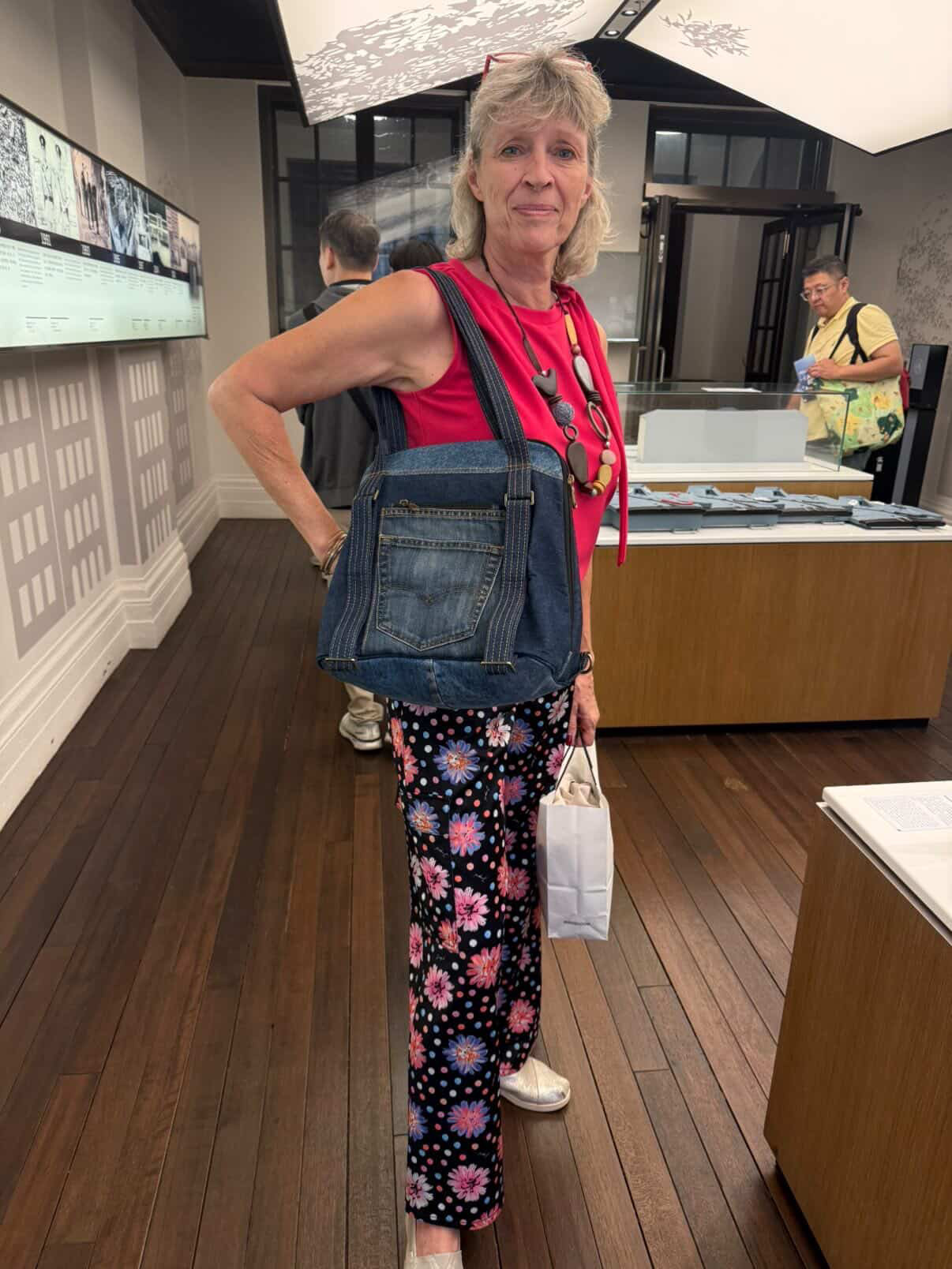Customer carrying Born Again as a tote while visiting a museum